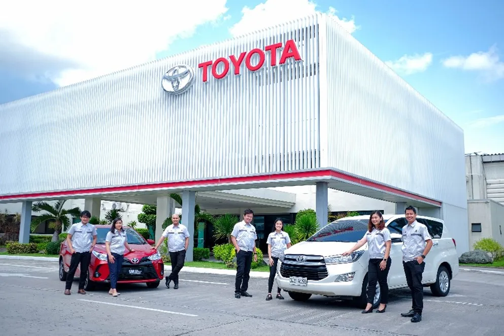 Philippine flag, Green Cross flag, and Toyota flag on flagpoles